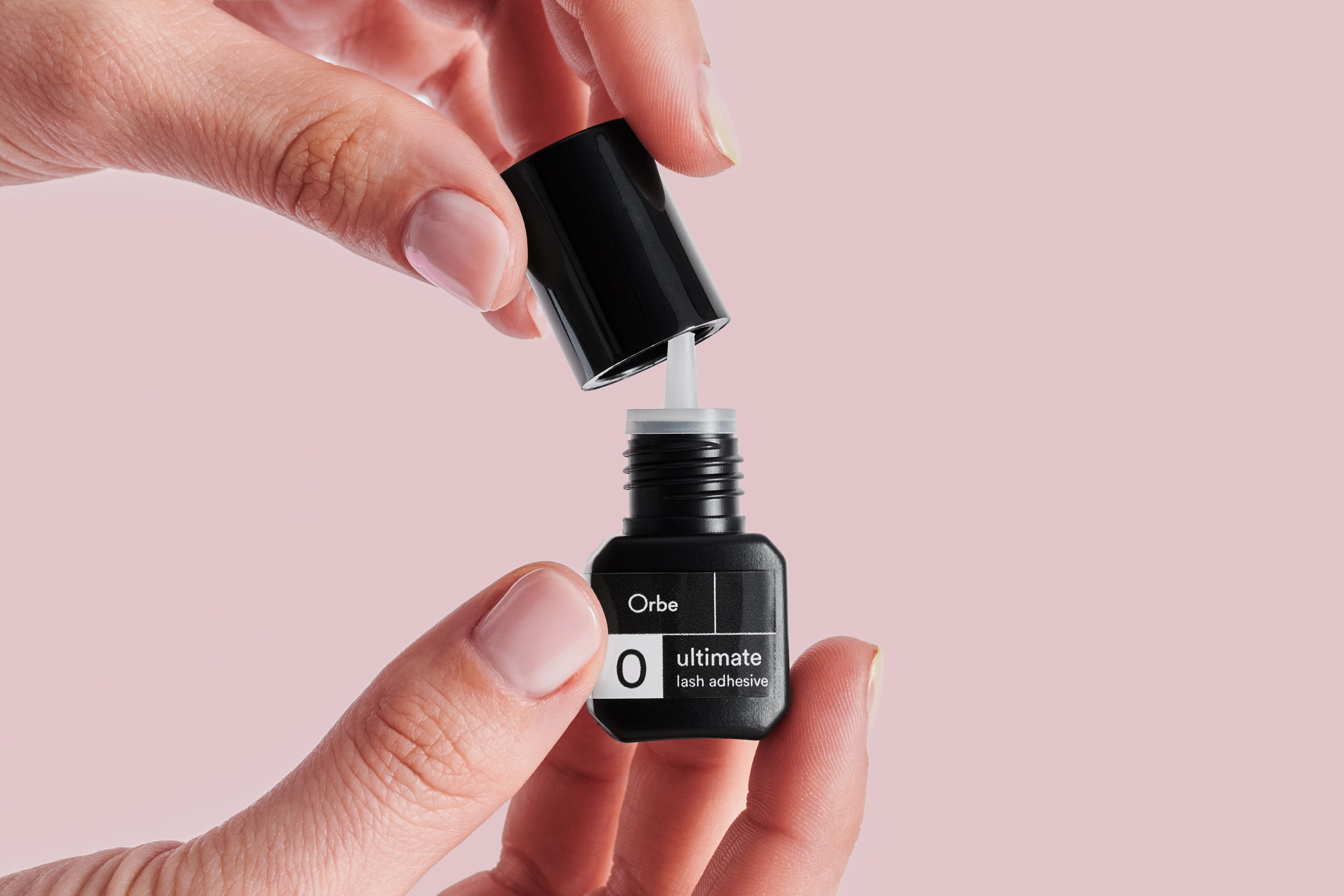 What is an eyelash adhesive and how does it work?