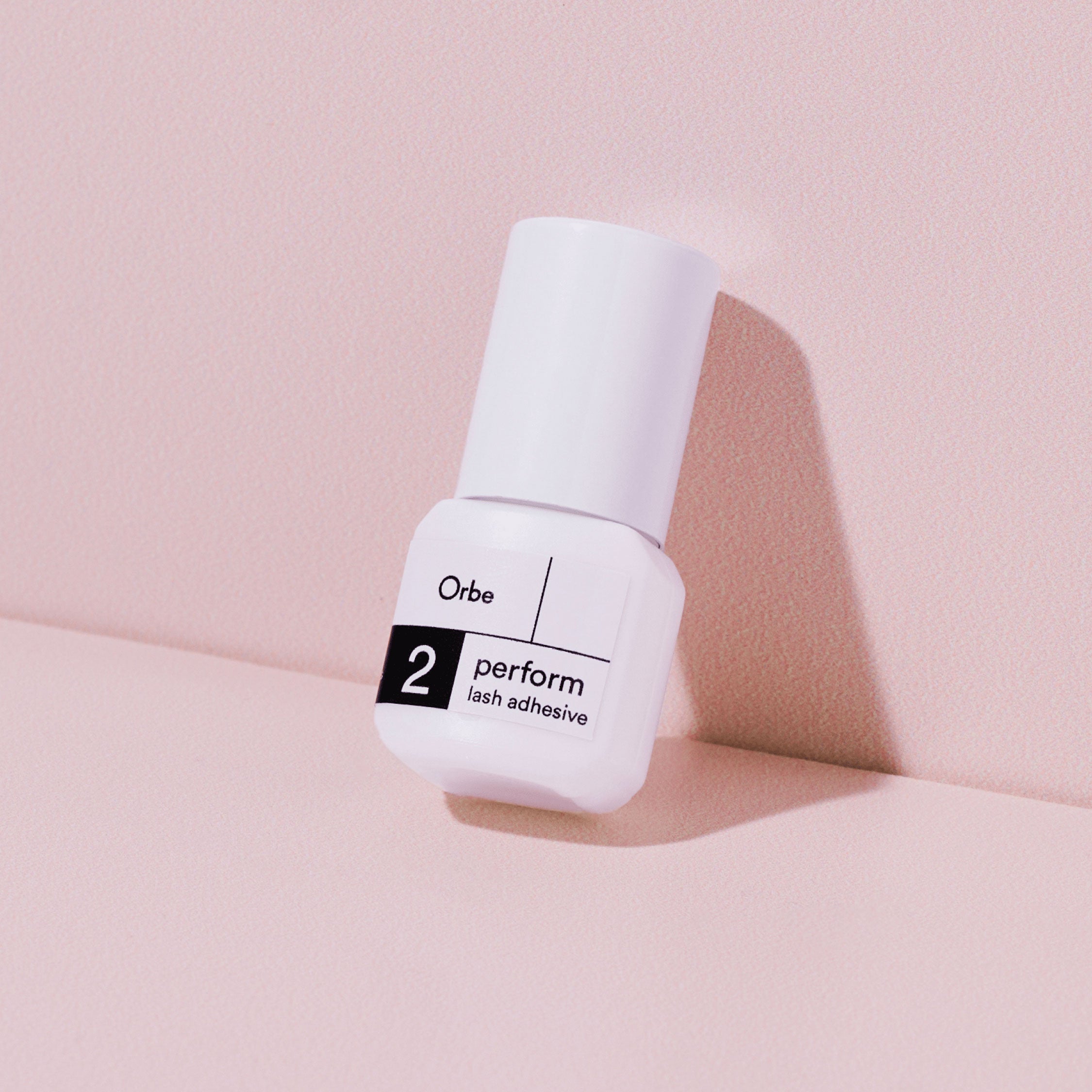 Orbe Perform 2 eyelash glue bottle. A PureForm® adhesive